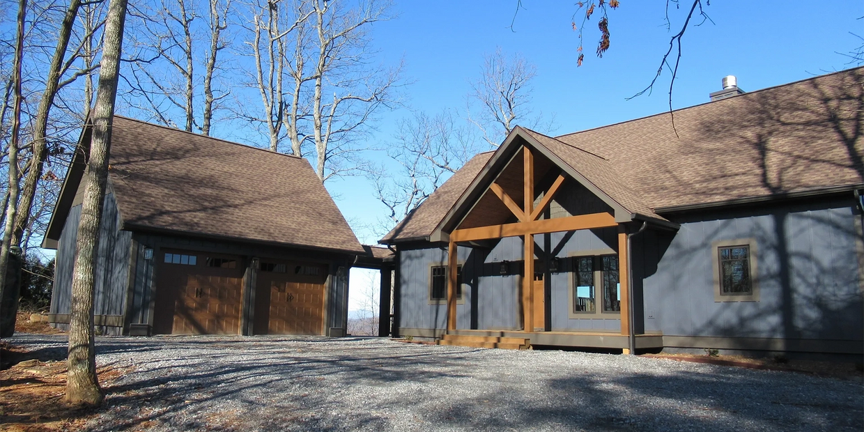 Custom timber frame home with detached garage by Full Circle Building Group