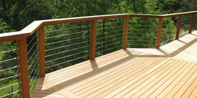 Custom wood deck with horizontal stainless steel cable railing by Full Circle Building Group