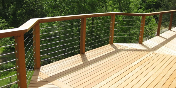 Custom wood deck with stainless steel cable railing by Full Circle Building Group