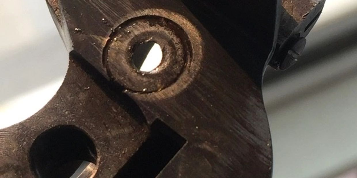 A badly worn recoil shield in need of replacement. 