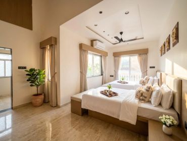 Bright bedroom with a large bed and natural light.