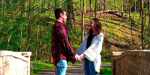 Couple looking at each other holding their hands