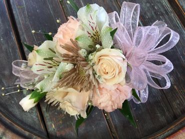 White and cream-colored flowers with a pink ribbon