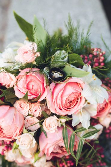 A close-up pink and white bouquet with ring