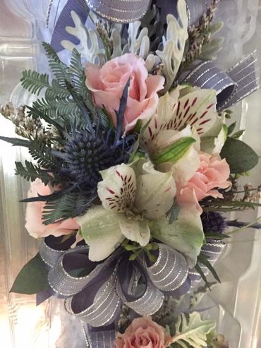 White and pink flowers with a purple ribbon