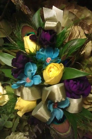 A corsage with purple yellow and blue flowers