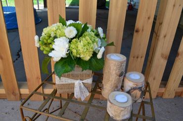 A green and white centerpiece with ribbon