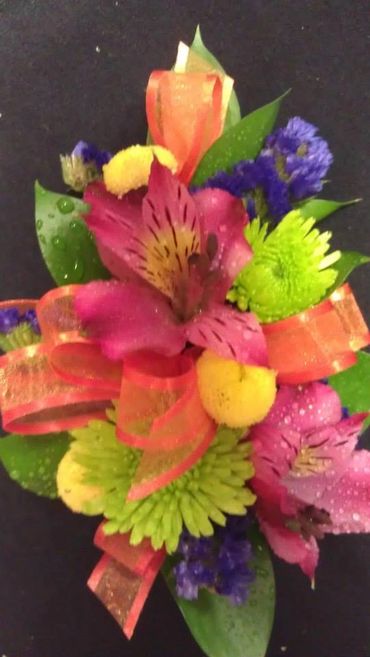 Pink, purple, yellow and blue flowers with greenery