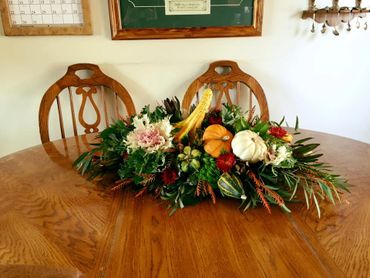 A centerpiece with vegetables and flowers