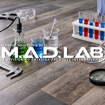 Laboratory setup with test tubes, beakers, and scientific tools on a wooden surface.