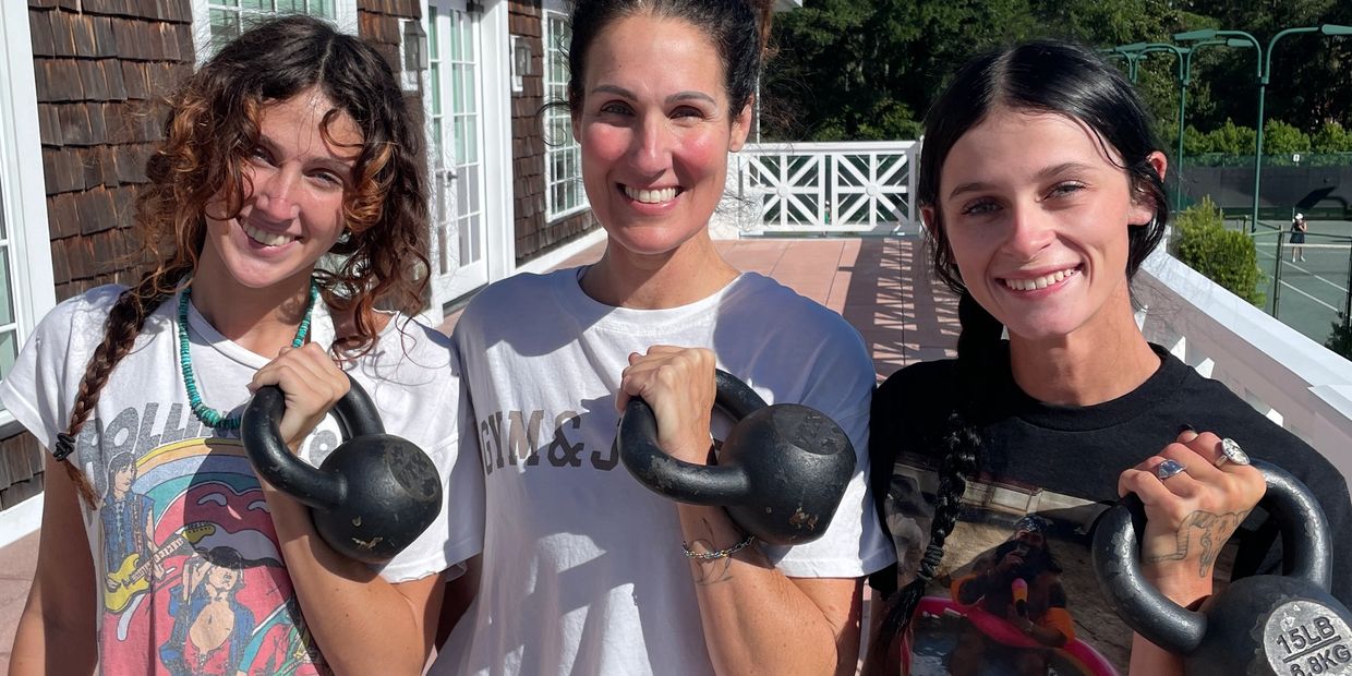 Group of women holding kettlebells during a semi-private personal training session in Wilmington, NC