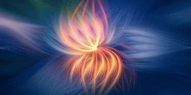 Abstract swirling light resembling a glowing flower in motion.