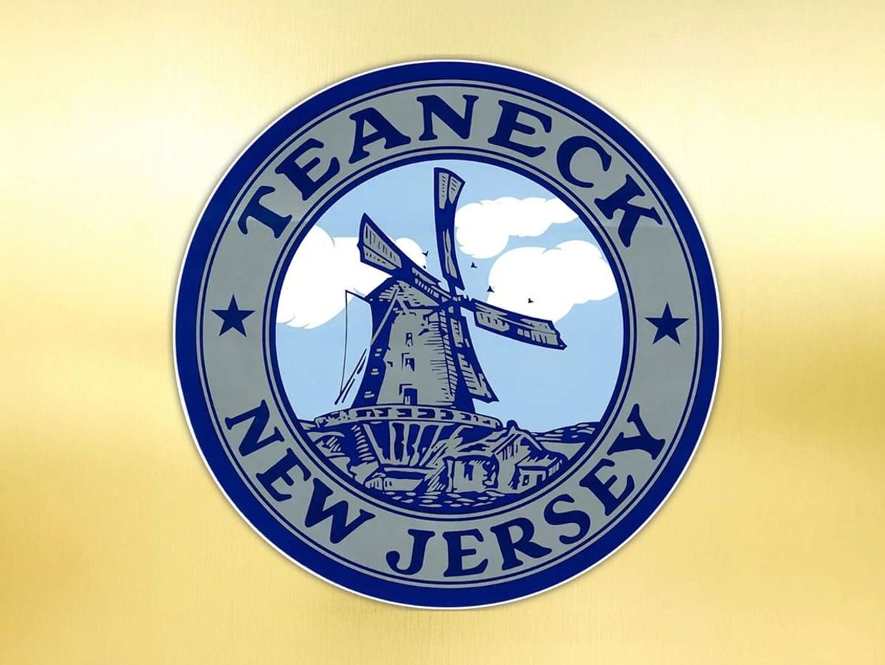 A patch with a lighthouse and windmill surrounded by the words "TEANECK, NEW JERSEY".