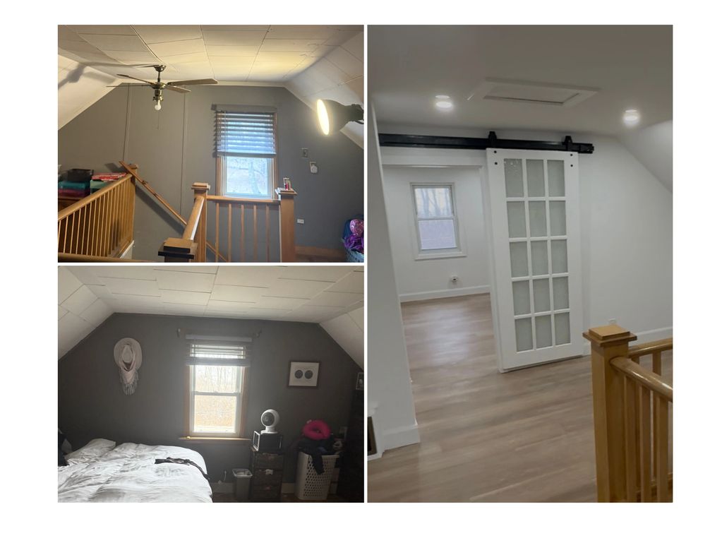A stairway and bedroom with gray walls and wood accents.