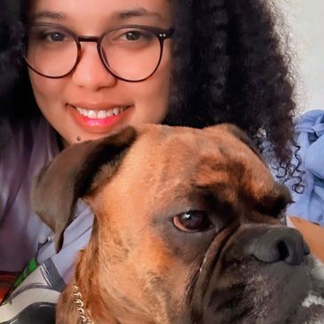 Smiling woman with glasses and her dog.