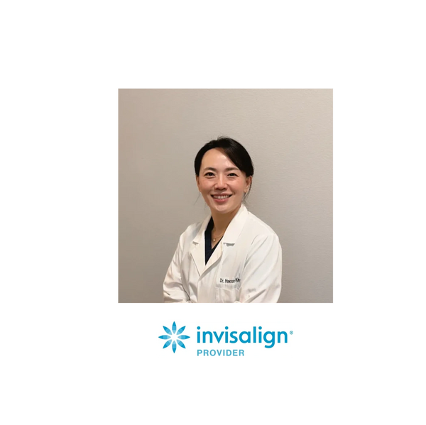 Smiling female dentist in white coat with Invisalign provider logo below.