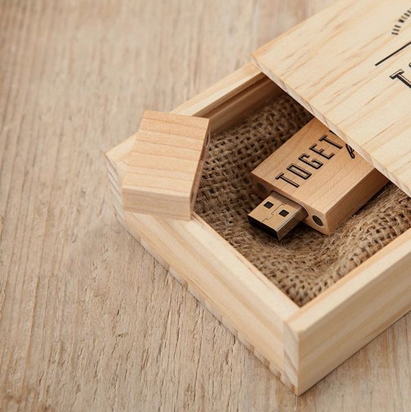 Wooden USB drive in a sliding wooden box on a rustic surface.