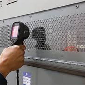 Person using infrared thermometer on a vent grille.