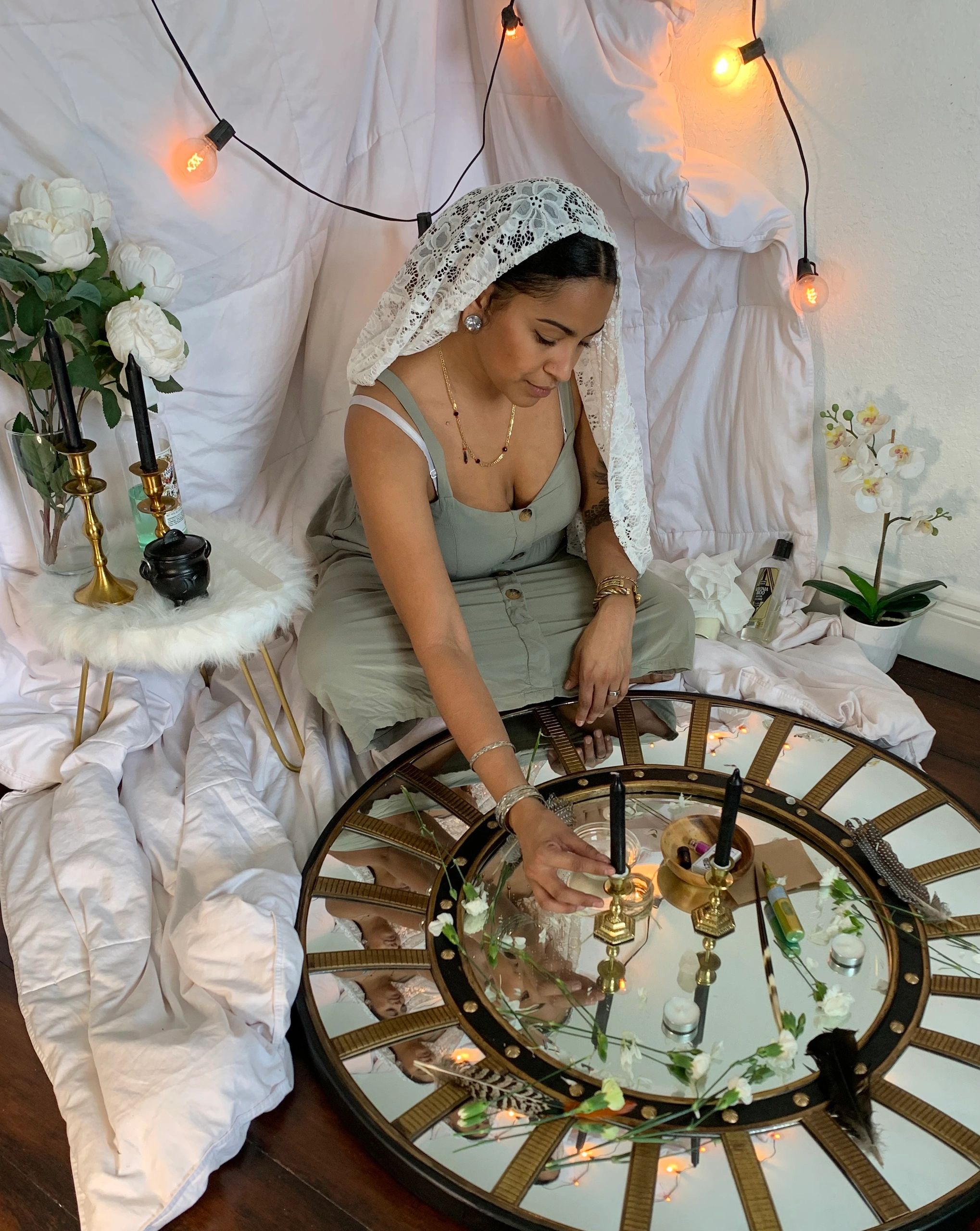 Dominican Spiritual Witch Advisor conducting a chord cutting ritual on an aesthetic round mirror.