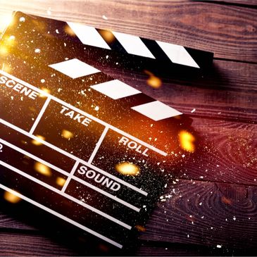 A clapperboard on a wooden surface with light effects.