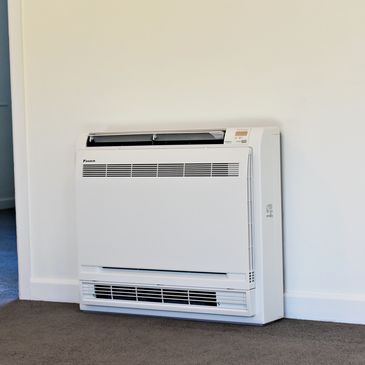 Floor mounted heat pump air conditioning system