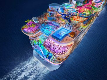 A brightly lit cruise ship at night.