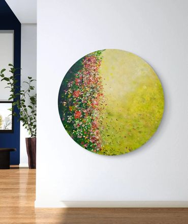 Round painting with floral and abstract yellow design on a white wall.