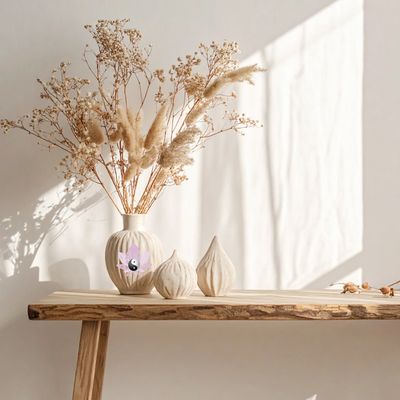 Minimalist dried flower arrangement on a wooden table with soft natural light.