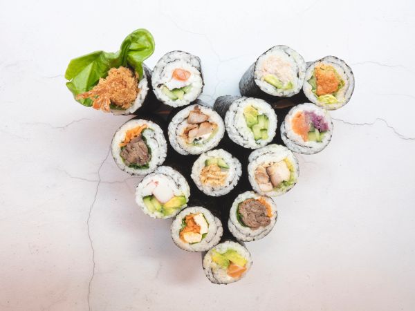 Assorted sushi rolls arranged in a flower shape.
