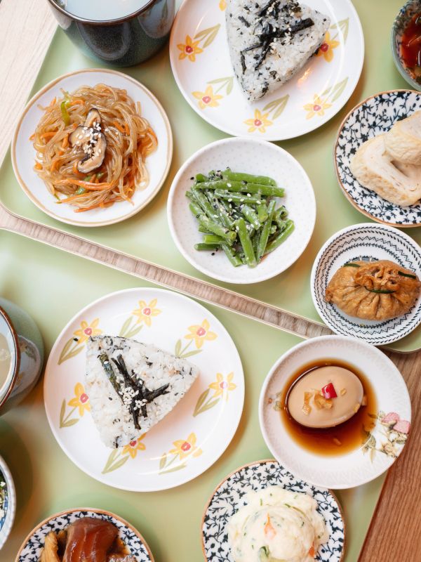 Various Japanese side dishes on decorative plates.