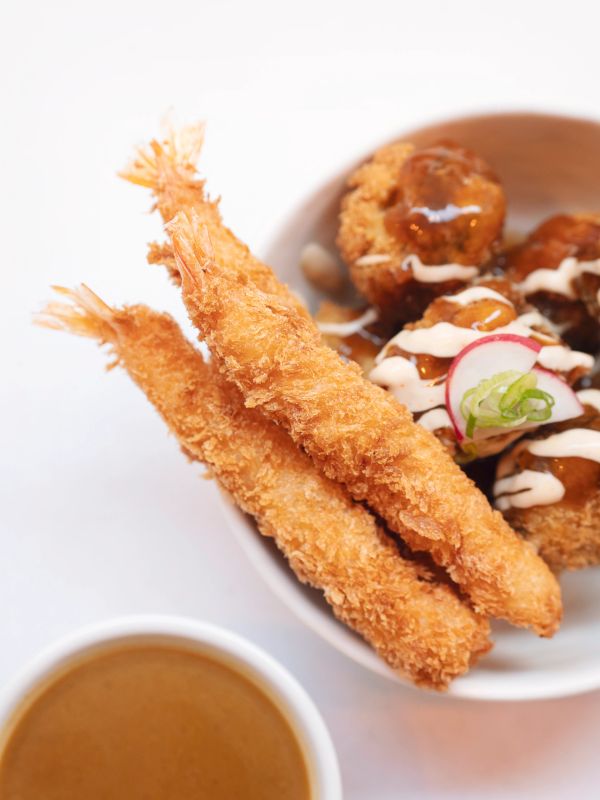 Close-up of crispy fried shrimp and sauce.