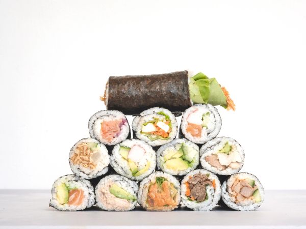 A pyramid stack of assorted sushi rolls.