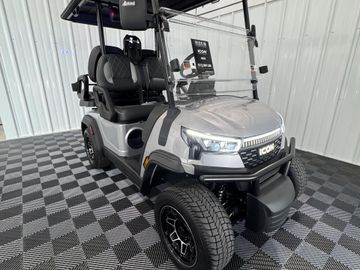 Silver ICON golf cart with black seats and modern design.