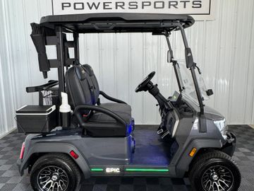A sleek, black golf cart with modern design and LED lights.