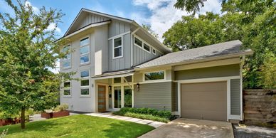 Modern two-story house with a garage and well-maintained lawn.