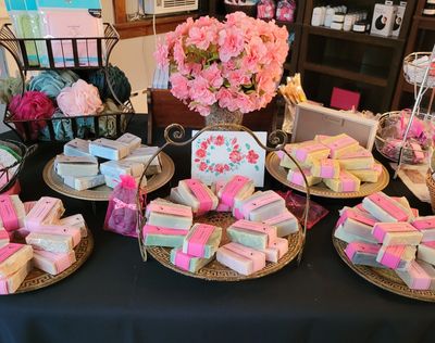 Table with soaps and flowers in boutique.