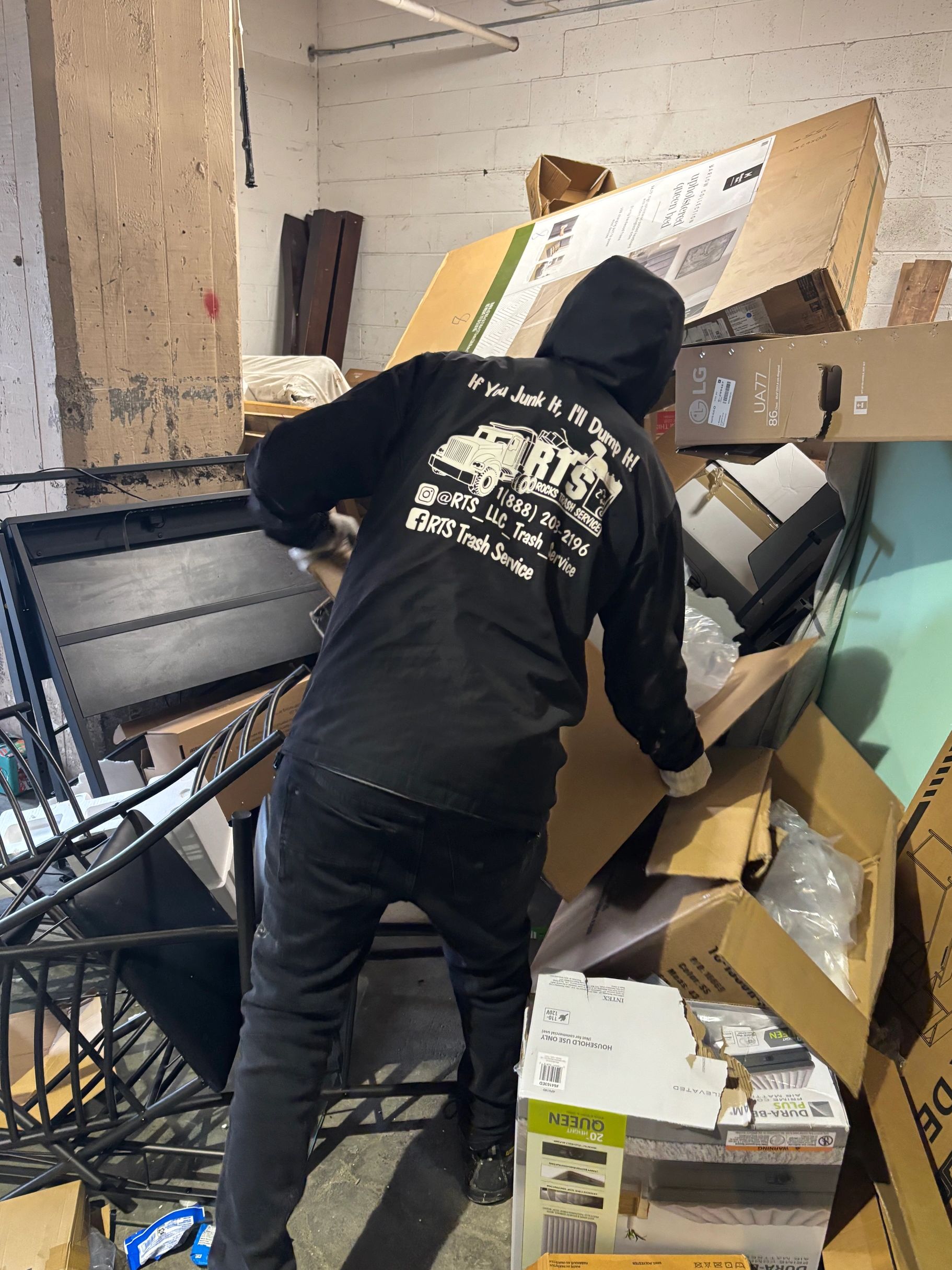 RTS Rocks Trash Service crew member removing unwanted furniture and household items during a propert