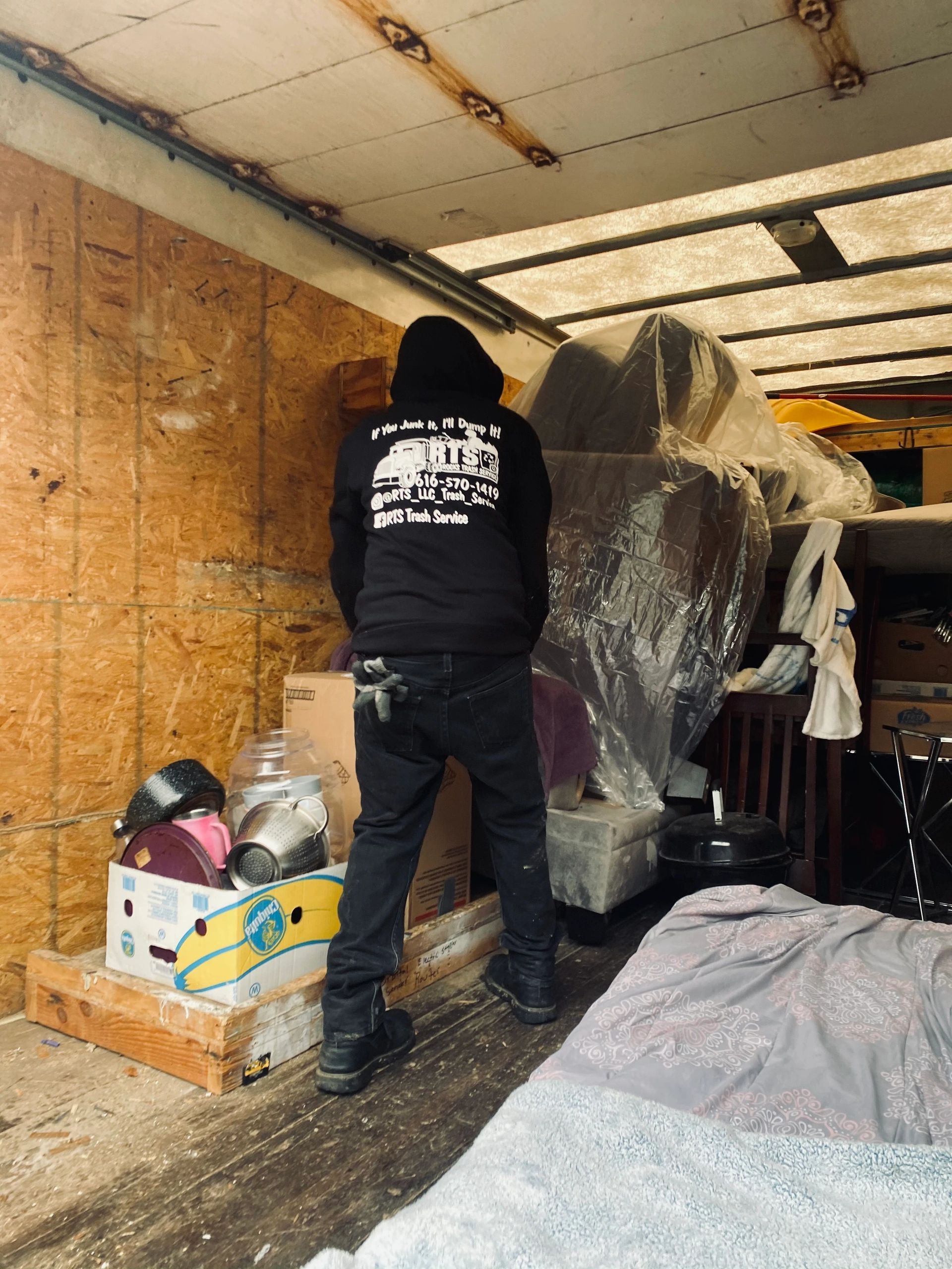 RTS Rocks Trash Service crew loading furniture and household items during a property cleanout in Wes