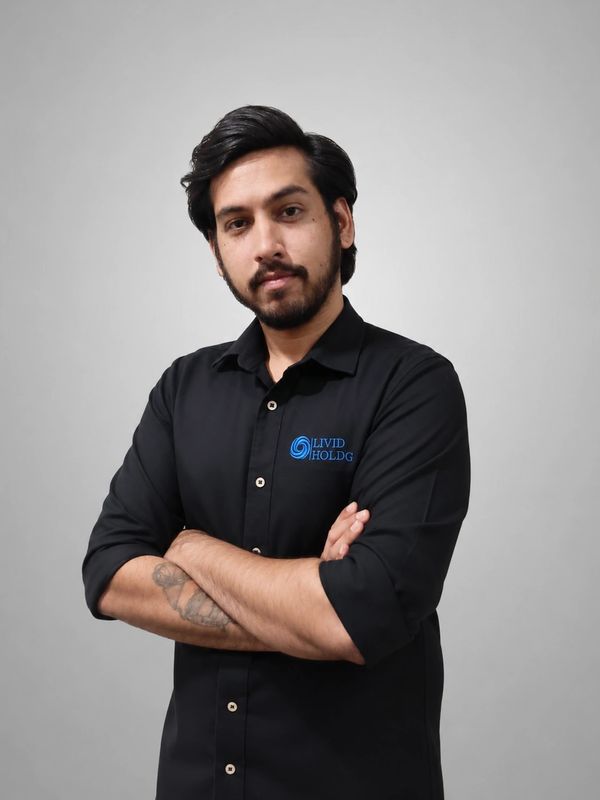 Man with folded arms wearing a black shirt with logo.
