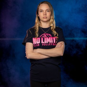 Determined woman with crossed arms in volleyball T-shirt.