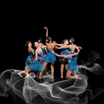 A group of dancers in blue costumes performing an artistic pose surrounded by smoke.