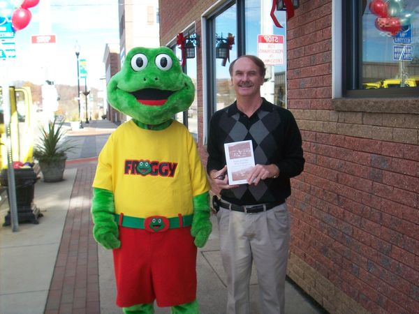 Steve Bodkins and Froggy Radio mascot outside of Rider Pharmacy in Fairmont, WV.