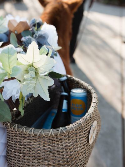 a basket with flowers and beverages 