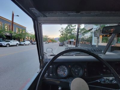 View from inside a vehicle looking out onto a quiet street.