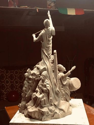 Intricate sculpture of three musicians playing traditional instruments.