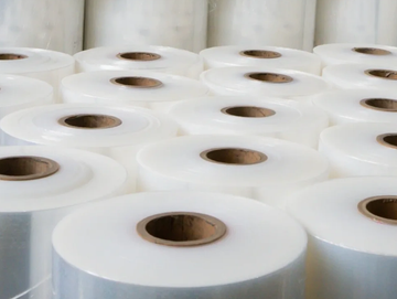 Rolls of clear plastic film stacked.