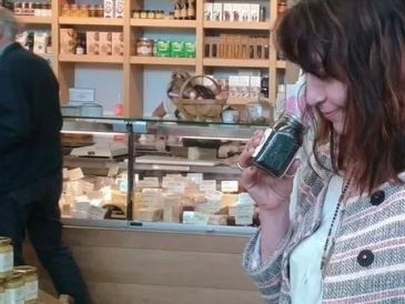 Woman smelling a jar in a shop.
