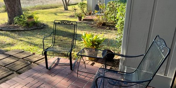 Covered porch seating at a coastal second home in Pawleys Island