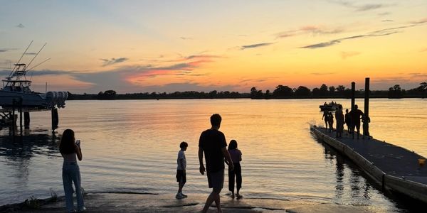 Sunset gathering along wth waterfront in Pawleys Island representating relationship-focused property