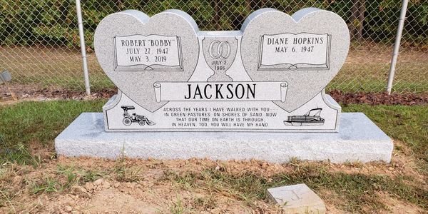 Double heart-shaped gravestone for Robert and Diane Jackson with a loving inscription.